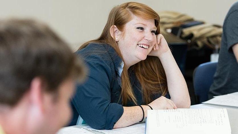 A student smiling in the classroom